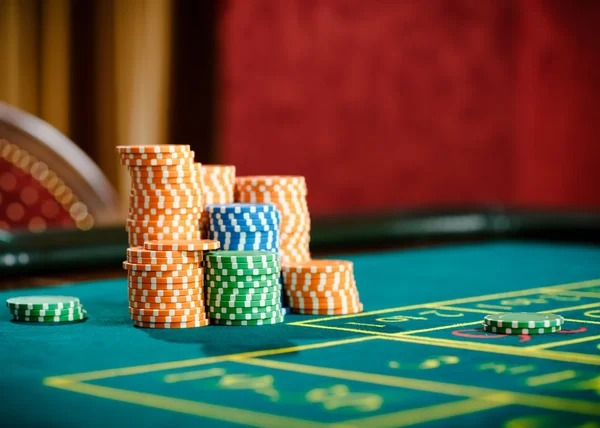 Baccarat studio setup Baccarat live dealer studio with esports match on secondary screen
